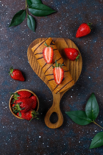 Free photo delicious strawberry cake roll with fresh strawberries,top view