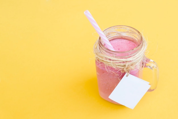 delicious strawberry smoothie with straw and label for mock up with space on the right