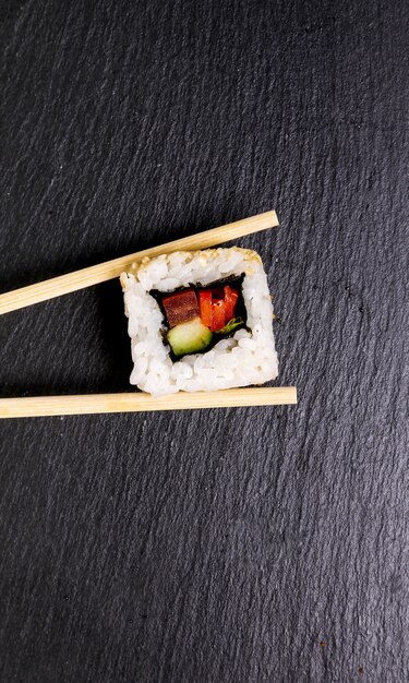 Delicious sushi on black plate