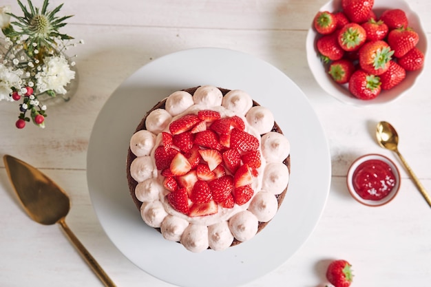 Delicious and sweet cake with strawberries and baiser on a plate