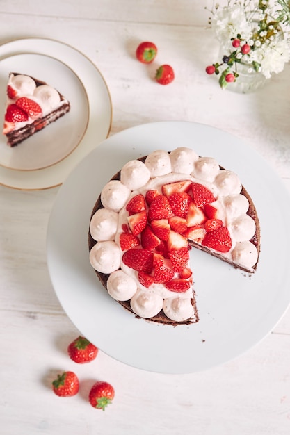 Free photo delicious and sweet cake with strawberries and baiser on a plate