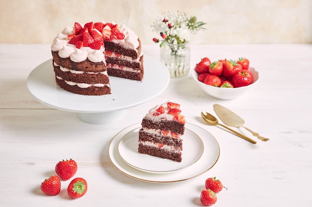 Delicious and sweet cake with strawberries and baiser on a plate