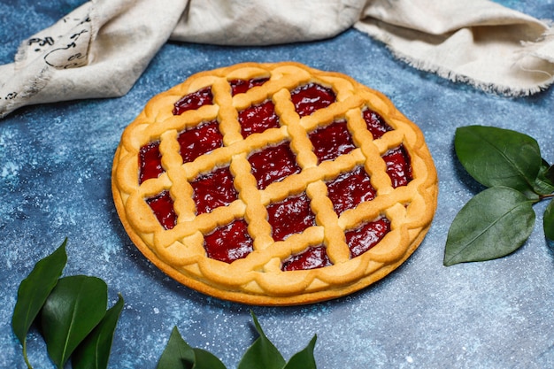 Delicious traditional berry cherry pie Crostata on grey dark surface