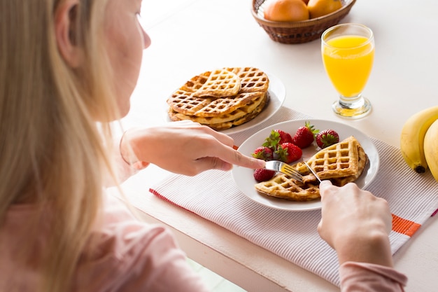 Delicious waffles with strawberries and juice