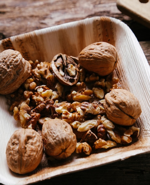 Free photo delicious walnuts on wooden bowl