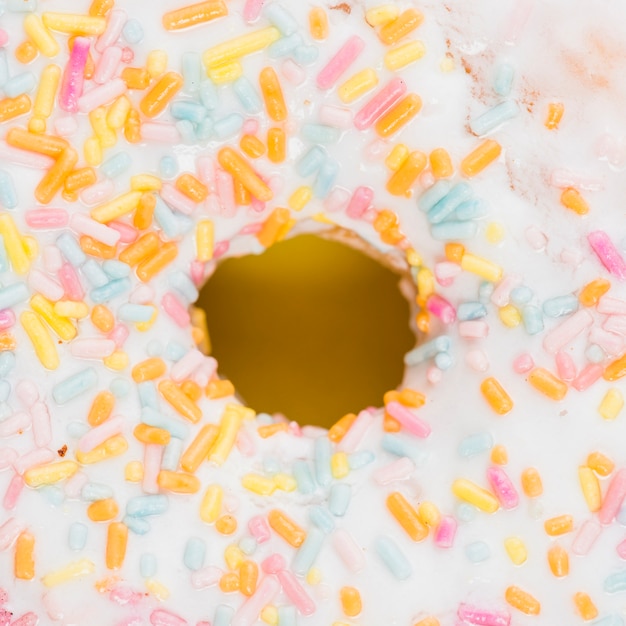 Delicious white chocolate doughnut with colorful sprinkles