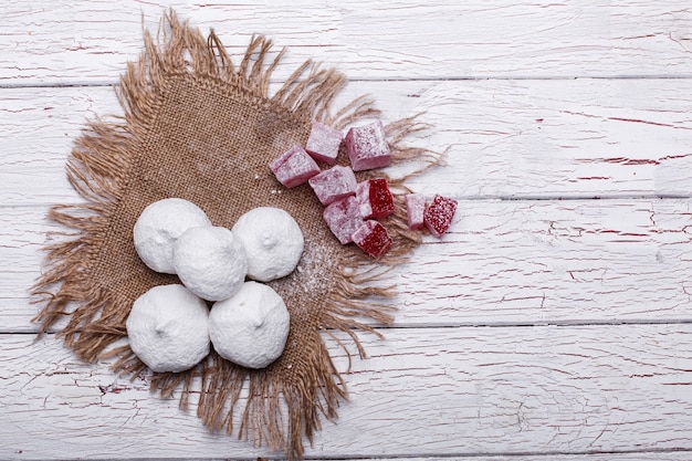 Free Photo delicious white and red cookies for tea served on white wooden table