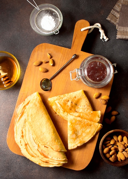 Delicious winter crepe dessert on cutting board top view