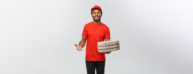 Delivery Concept Portrait of Handsome African American Pizza delivery man Isolated on Grey studio Background Copy Space