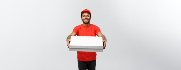 Delivery Concept Portrait of Handsome African American Pizza delivery man Isolated on Grey studio Background Copy Space