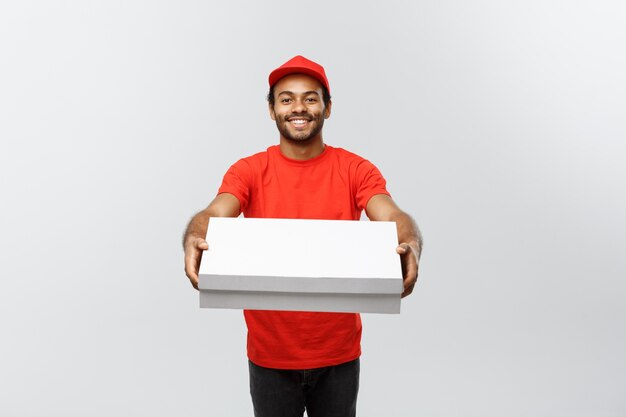 Delivery Concept - Portrait of Handsome African American Pizza delivery man. Isolated on Grey studio Background. Copy Space.