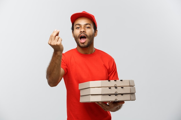 Free Photo delivery concept - portrait of handsome african american pizza delivery man. isolated on grey studio background. copy space.