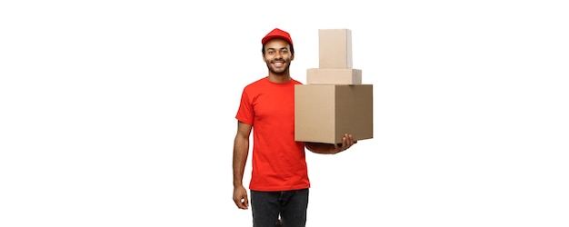 Delivery Concept Portrait of Happy African American delivery man in red cloth holding a box package Isolated on white studio Background Copy Space