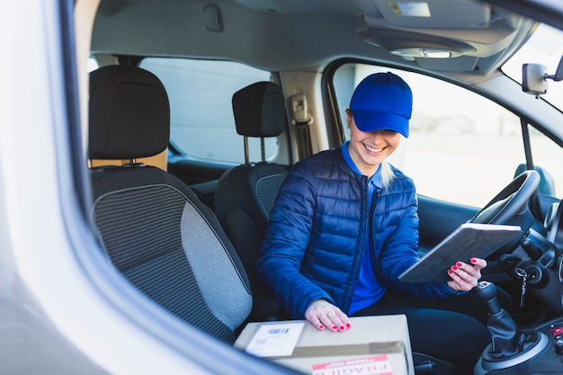 Free Photo delivery girl with tablet in car