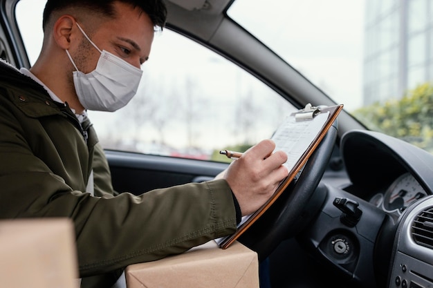 Delivery male with mask and packages