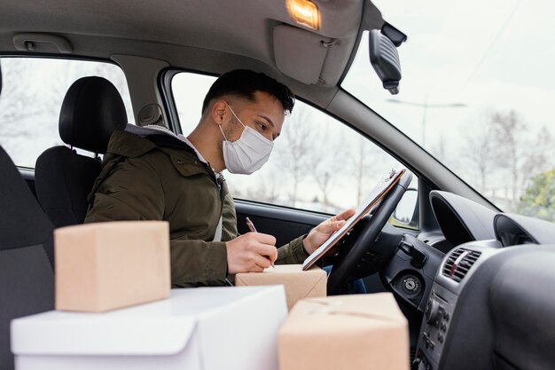 Delivery male with mask and packages