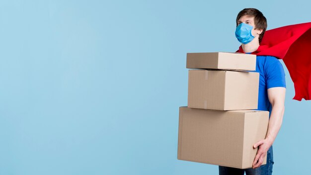 Delivery man carrying boxes