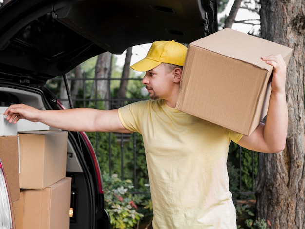 Delivery man holding box on shoulder