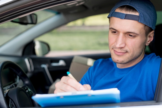 Free photo delivery man signing paper