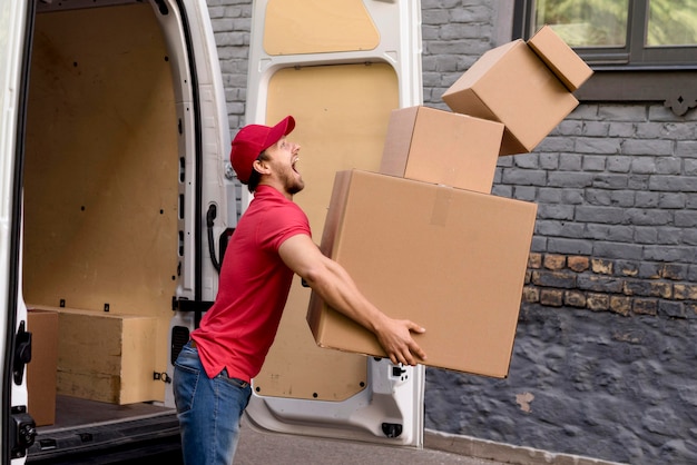 Free photo delivery man with stack of packages