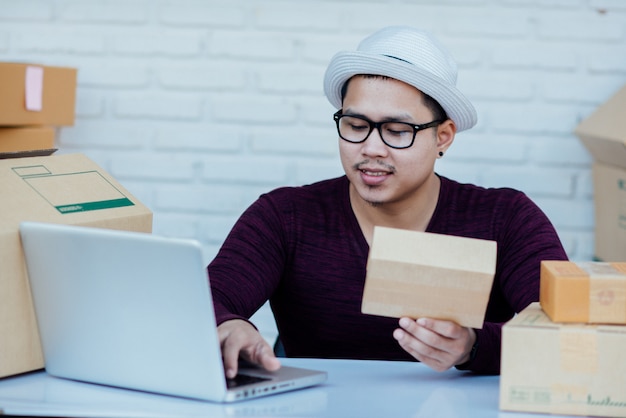 Delivery service working with papers among parcels at table