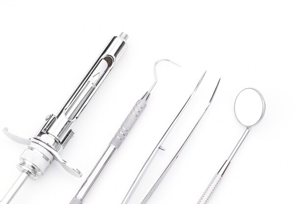 Dental tools and equipment on white background