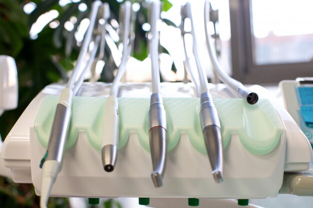 Dental tools with pipes fixed on dental chair