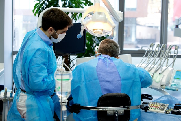 Dentist and assistant while work with a patient