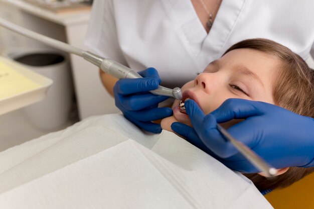 Dentist cleaning child's teeth