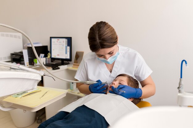 Dentist cleaning child's teeth