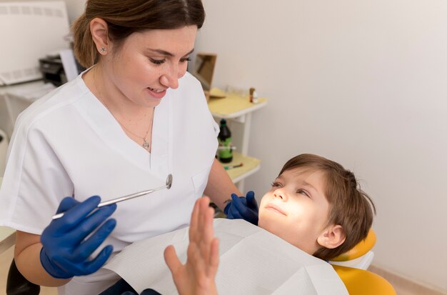 Dentist cleaning child's teeth