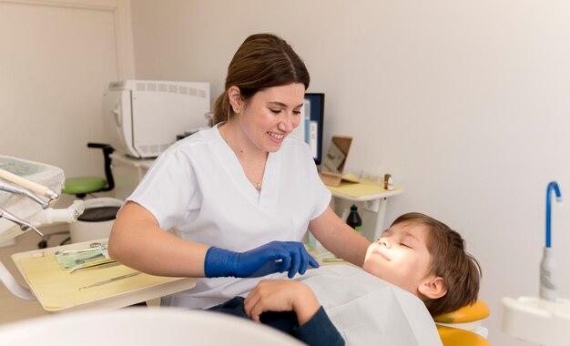 Dentist cleaning child's teeth