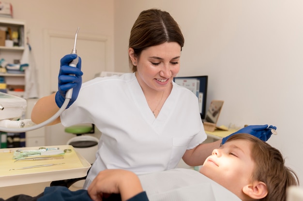 Dentist cleaning child's teeth