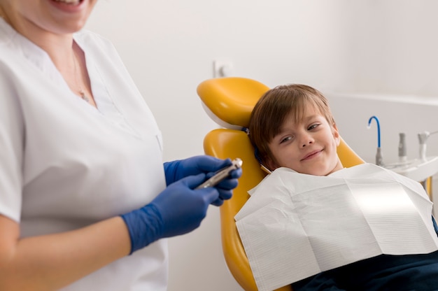 Dentist cleaning child's teeth