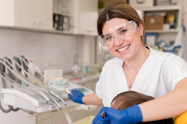 Dentist cleaning child's teeth