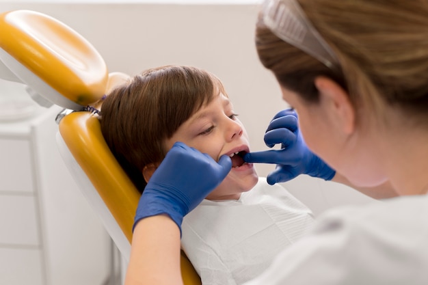 Dentist cleaning child's teeth