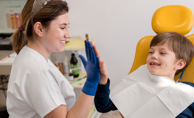 Dentist cleaning child's teeth