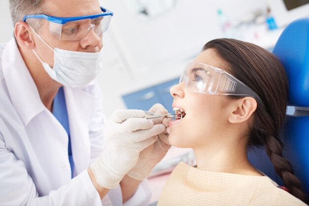 Dentist examining a patient's teeth