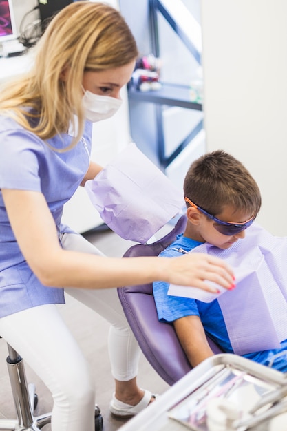 Dentist preparing boy for dental checkup