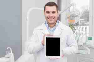 Free photo dentist presenting tablet