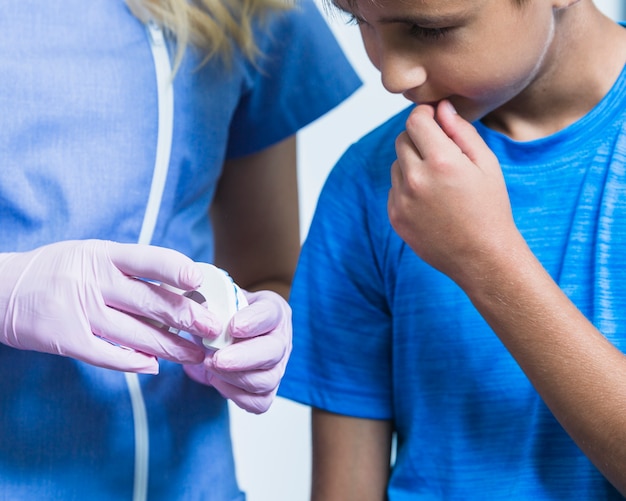 Free Photo dentist's hand showing teeth plaster mold to boy