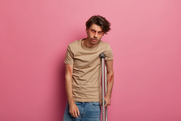 Free photo depressed man with crutches suffers because of driver negligence