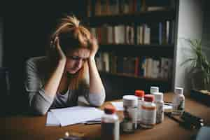 Free photo depressed person looking at their meds