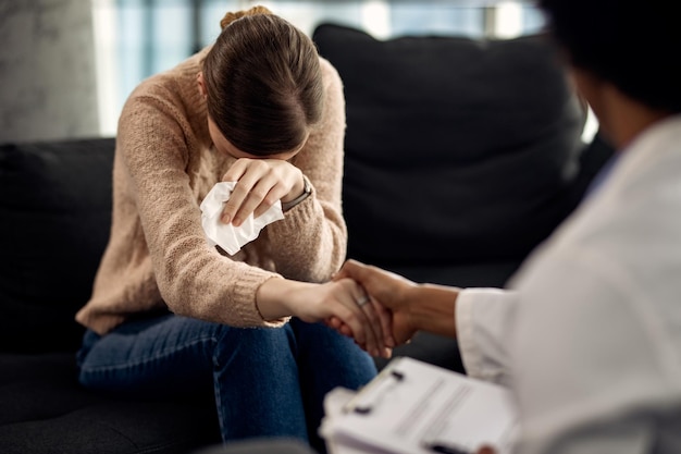 Free photo depressed woman seeking solace from her psychotherapist