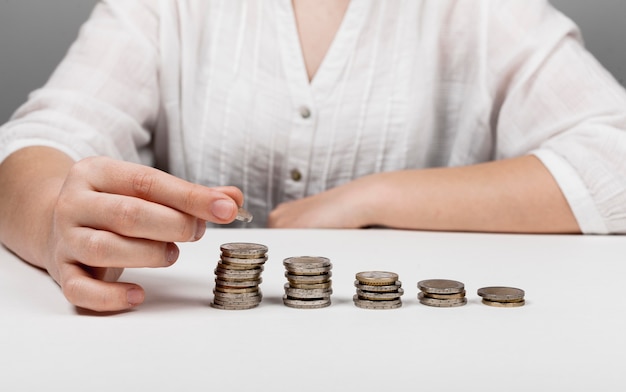 Descending piles of coins and woman