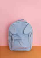 Free photo desk arrangement with blue backpack