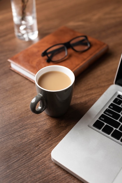 Free photo desk arrangement with coffee high angle