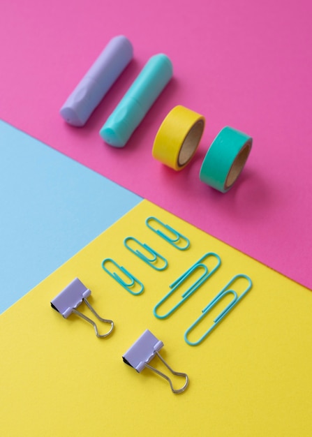 Free Photo desk arrangement with colorful tape and paper clips