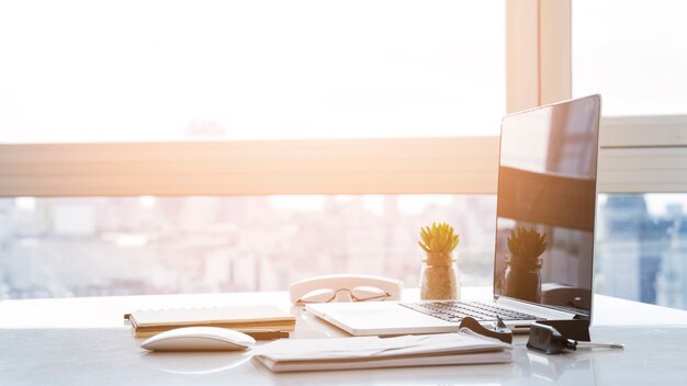 Desk arrangement with laptop on table