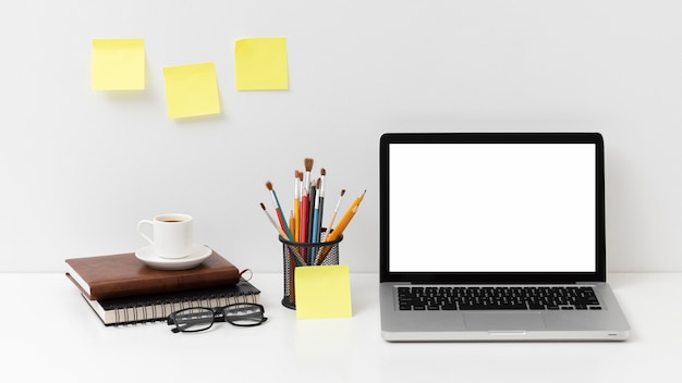 Desk elements arrangement with empty screen laptop